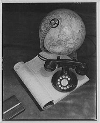 Historical image of globe and phone on top of an open book.